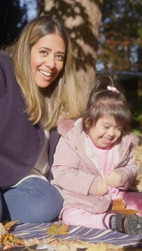 MS SLO MO Mother and daughter (2-3) with Down syndrome relaxing in park