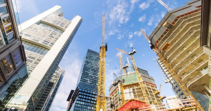 Skyscraper construction time lapse in urban area. New residential and commercial buildings in Frankfurt, Germany.
