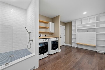 Modern, white washer and dryer set in a contemporary bathroom