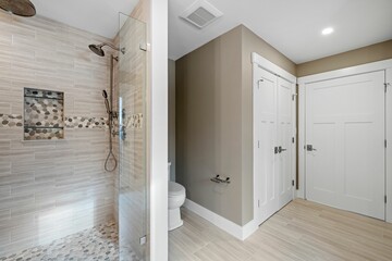 Bathroom with open shower doors and tiles on the wall
