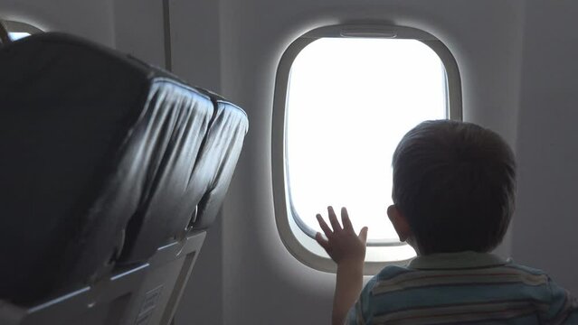 Little Kid Opening Window Cover In The Airplane