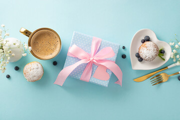 Happy Mother's Day! Top view flat lay of cupcakes, gifts, postcard, coffee, and gypsophila flowers...