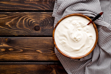 White dip sauce - sour cream or yogurt in wooden bowl