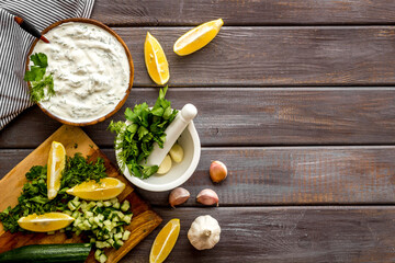 Homemade cooking of greek dip sauce sour cream with herbs and cucumber