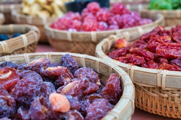 Closeup of dried fruits in wicker bowls.