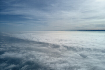 Aerial view from high altitude of earth covered with puffy rainy clouds forming before rainstorm
