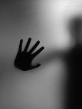 silhouette blur of hand on mirror halloween concept