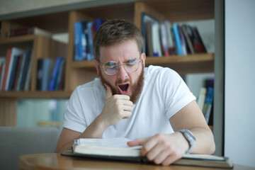 Portrait of tired overworked guy, exhausted young man in glasses college or university student is...