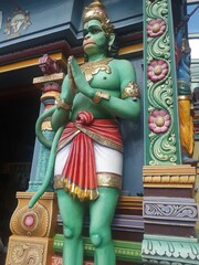 Statue of a green mythical creature at the entrance of the historic Sri Srinivasa Perumal Temple