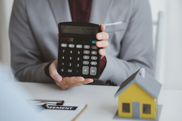 Real estate agents explain models of housing estates in projects to elaborate to clients,...
