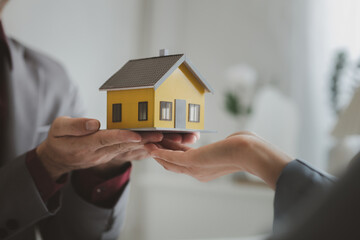 Real estate agents explain models of housing estates in projects to elaborate to clients,...