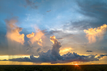 Cumulonimbus clouds forming before thunderstorm on evening sky. Changing stormy cloudscape weather...