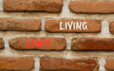 Start living symbol. Concept words Start living on beautiful red brown brick wall on beautiful red brown brick wall background. Business and Start living concept. Copy space.