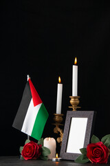 burning candles with palestinian flag and flowers on a dark background israel death funeral