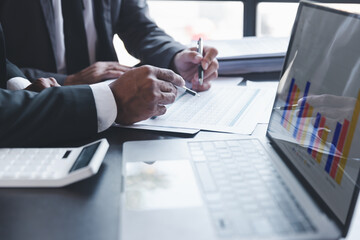 Finance and investment concept, Businessman present business finance investment plan with his partner, Investor colleagues discussing new investment plan by financial graph data on office table