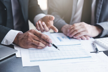 Finance and investment concept, Businessman present business finance investment plan with his partner, Investor colleagues discussing new investment plan by financial graph data on office table