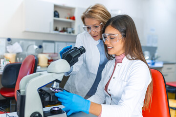 Medical Science Laboratory: Beautiful Scientist Looking Under Microscope Does Analysis of Test...