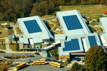 Roof of american school building covered with photovoltaic solar panels for production of electric...