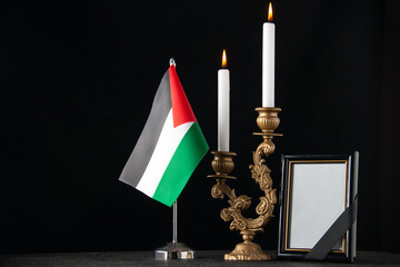 front view burning candles with palestinian flag and picture frame dark background funeral death