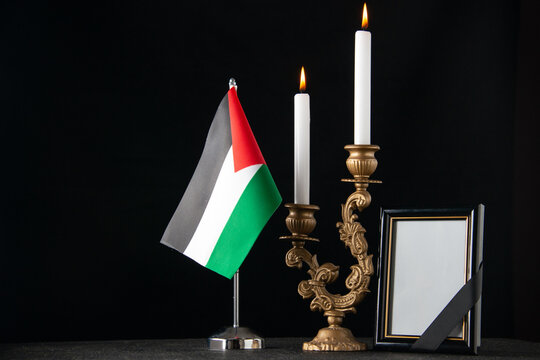 front view burning candles with palestinian flag and picture frame dark background funeral death