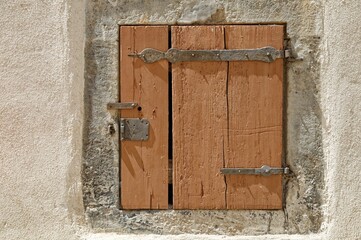 Wooden door of white stone building in countryside with vintage texture