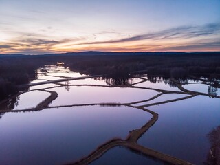 an aerial photo taken at dusk showing the water channels that lead to the lake