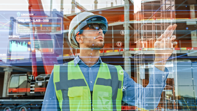 Futuristic Architectural Engineer Wearing Augmented Reality Headset, Uses Gestures to Create 3D Graphics VFX Model of a Building with Infographics. In Background Construction Site in Progress