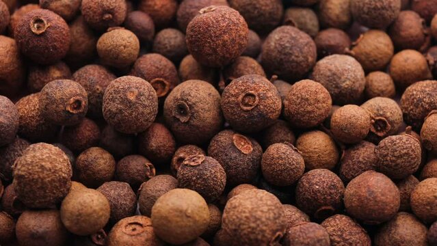 allspice peas, rotation in circle. Spices Turning. selective focus