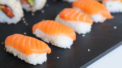 close up of sushi set on dark tray
