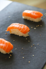 close up of nigiri sushis on dark tray
