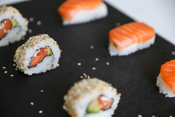 close up of sushi set on dark tray