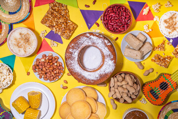 Traditional Festa Junina Summer Festival Carnival Food. Traditional Brazilian Festa Junina dishes and snacks - popcorn, peanuts, corn cake and cookie, pacoca, with holiday decorations and accessories