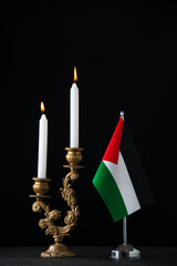 front view of elegant candlestick with candles on a dark background gold palestine death funeral