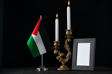 front view of elegant candlestick with candles on dark surface gold palestine death funeral
