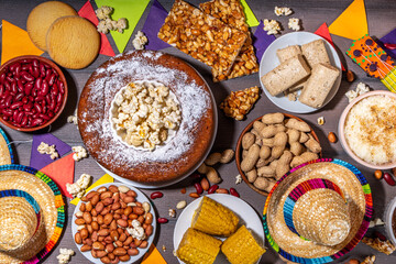 Traditional Festa Junina Summer Festival Carnival Food. Traditional Brazilian Festa Junina dishes and snacks - popcorn, peanuts, corn cake and cookie, pacoca, with holiday decorations and accessories