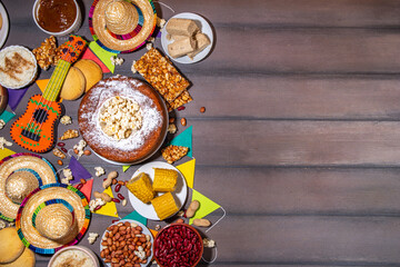 Traditional Festa Junina Summer Festival Carnival Food. Traditional Brazilian Festa Junina dishes and snacks - popcorn, peanuts, corn cake and cookie, pacoca, with holiday decorations and accessories