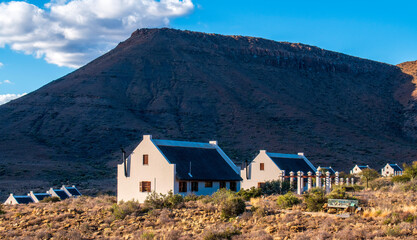 Rest camp. Guest chalets beneath the Nuweveld mountains in the Karoo National Park. 