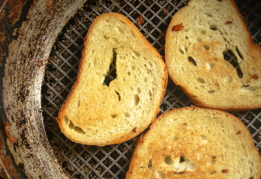 Toast in a pan. Bread with a golden crust after frying. Grilled bread in a frying pan.