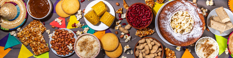 Traditional Festa Junina Summer Festival Carnival Food. Traditional Brazilian Festa Junina dishes and snacks - popcorn, peanuts, corn cake and cookie, pacoca, with holiday decorations and accessories