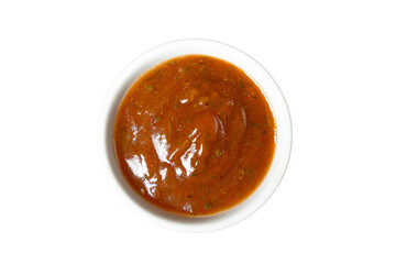 Sweet and sour sauce in a bowl isolated on white background. Red hot sauce from chilli peppers and...