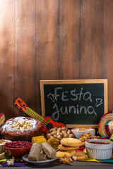 Traditional Festa Junina Summer Festival Carnival Food. Traditional Brazilian Festa Junina dishes and snacks - popcorn, peanuts, corn cake and cookie, pacoca, with holiday decorations and accessories
