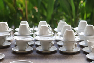 arrangement of white coffee cups in outdoor restaurant