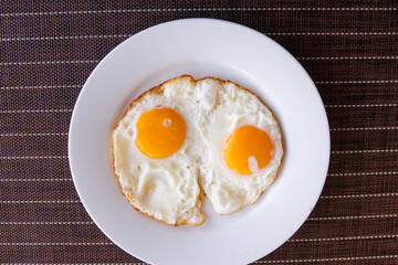 fried egg, on a white ceramic plate