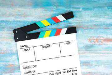 A movie clapper on blue wooden background. Film, cinema and video photography concept.