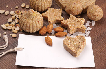 Homemade healthy and sweet groundnut or peanut and Jaggery Laddoo, delicious indian sweet served on a wooden background.Roasted peanut isolated.