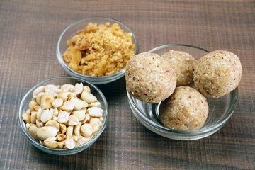 Homemade healthy and sweet groundnut or peanut and Jaggery Laddoo, delicious indian sweet served on a wooden background.Roasted peanut isolated.