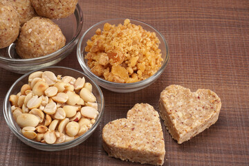 Homemade healthy and sweet groundnut or peanut and Jaggery Laddoo, delicious indian sweet served on a wooden background.Roasted peanut isolated.