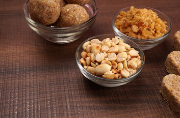 Homemade healthy and sweet groundnut or peanut and Jaggery Laddoo, delicious indian sweet served on a wooden background.Roasted peanut isolated.