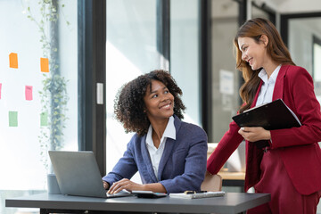 Asian and African young entrepreneurs Africans brainstorming on real estate projects, investments, finance business Together seamlessly in the office.