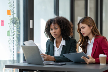 Young Asian and African businesswoman Africans brainstorming on real estate projects. investment plan Financial business together in the office management concept management.